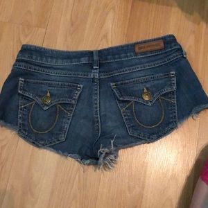 A pair of size 26 True Religion cutoff shorts
